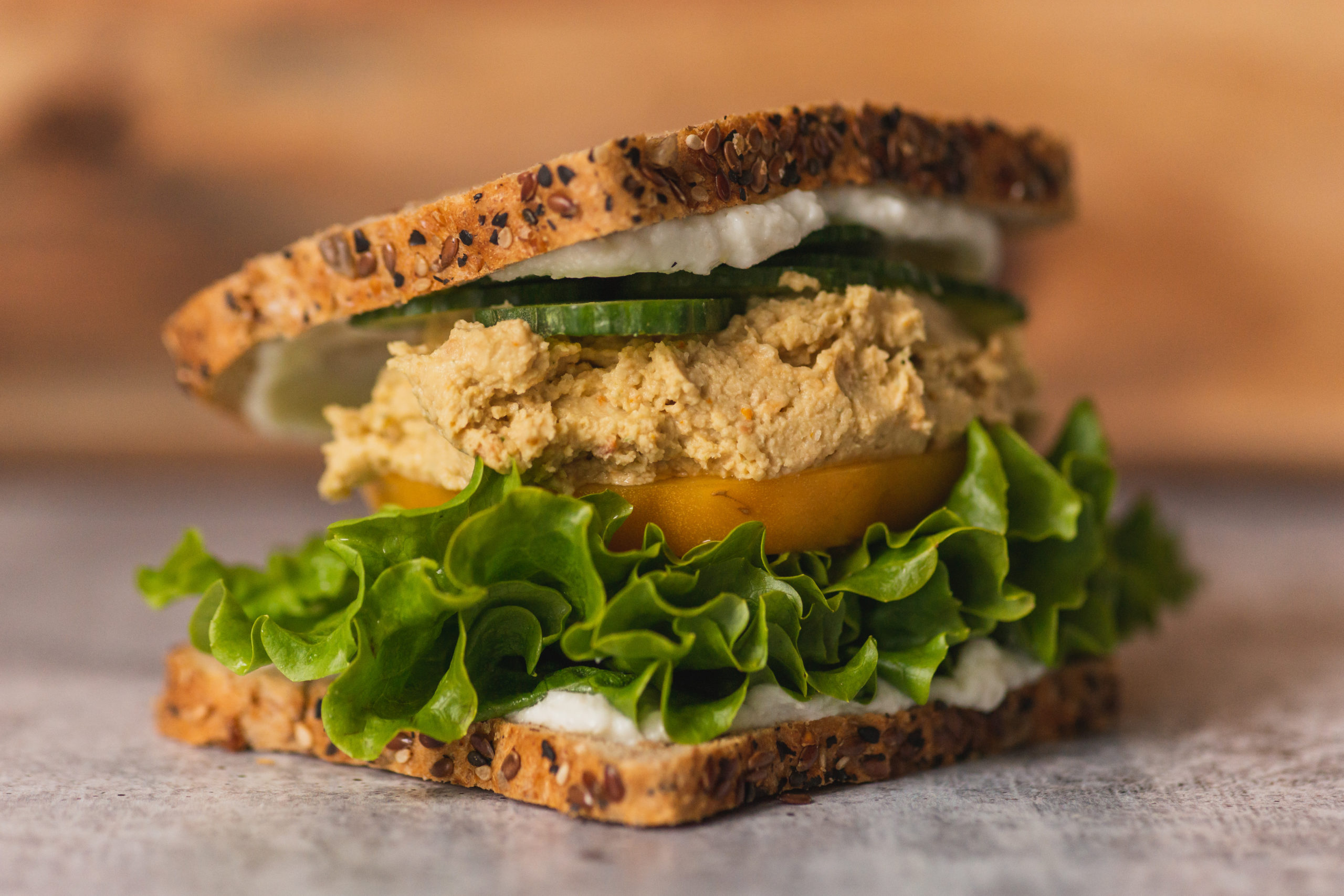 Vegan hummus & toum garlic sauce in healthy sandwich.